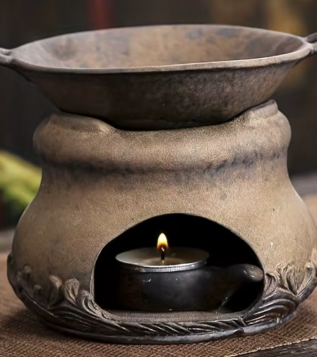 Diffuseur à chaleur douce avec bougie allumée, diffusant une ambiance chaleureuse dans un intérieur zen.